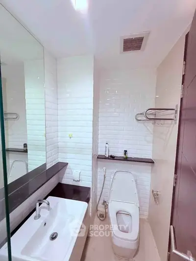Modern bathroom with sleek white tiles and contemporary fixtures