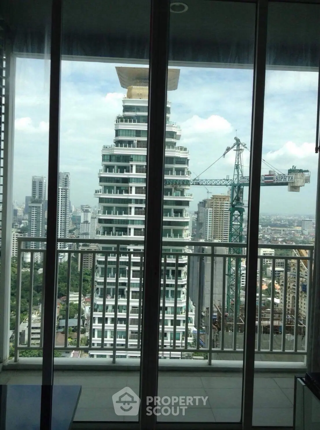 Stunning cityscape view from a high-rise balcony with modern architecture.