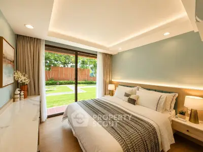 Luxurious bedroom with garden view, featuring elegant decor and natural light.