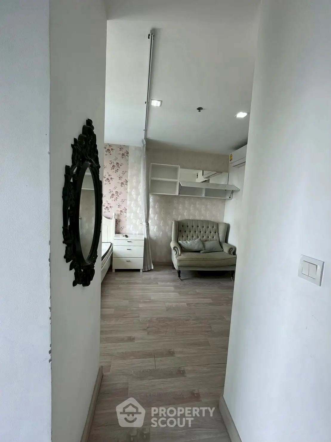 Charming interior with elegant sofa and floral wallpaper, perfect for cozy living.