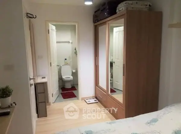 Cozy bedroom with ensuite bathroom and mirrored wardrobe