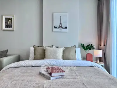 Elegant bedroom with cozy bedding and stylish decor, featuring a Paris-themed artwork and soft lighting.