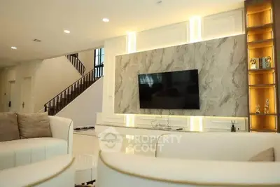 Luxurious living room with modern TV setup and elegant lighting