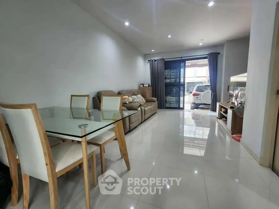 Spacious living room with modern furniture and large windows for natural light.