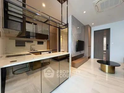 Modern open-layout kitchen and living area with sleek design and marble flooring.