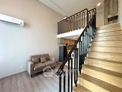 Modern duplex living room with stylish staircase and cozy sofa