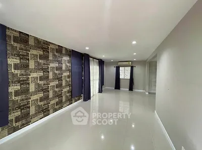 Spacious living room with modern decor and large windows for natural light.