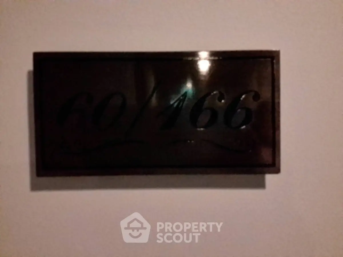 Elegant room number plaque on a wall, showcasing modern design and style.