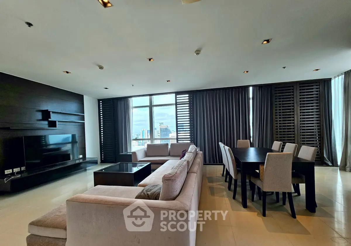 Luxurious living room with modern furniture and stunning city view, perfect for entertaining guests.