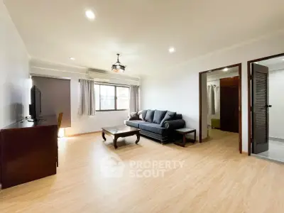 Spacious living room with elegant wooden flooring and cozy seating area.