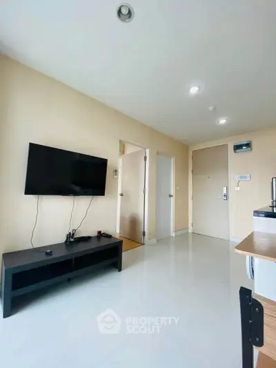Modern living room with wall-mounted TV and sleek furniture