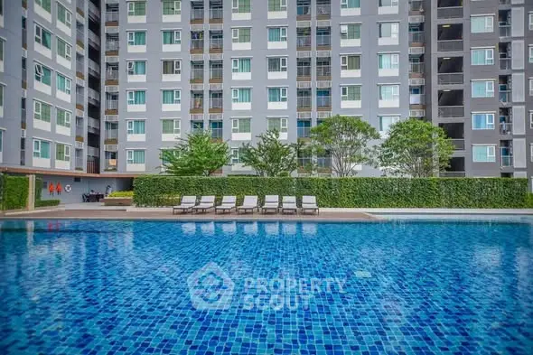 Luxurious apartment complex with a stunning outdoor pool and modern facade.