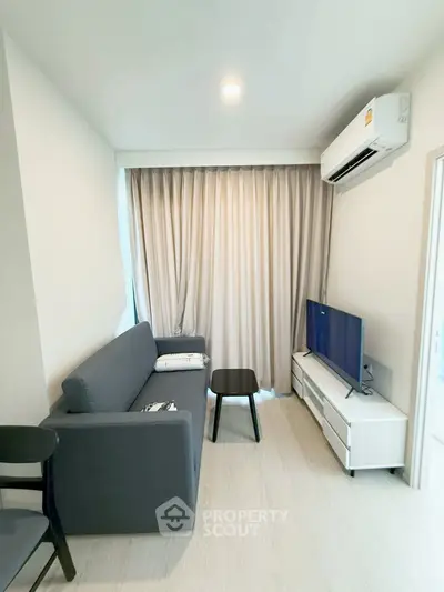 Modern living room with sleek furniture and natural light, perfect for cozy relaxation.