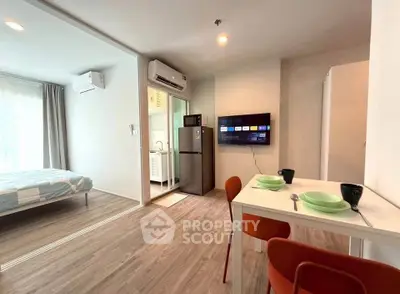Modern studio apartment with open layout, featuring a cozy living area, compact kitchen, and bright bedroom.