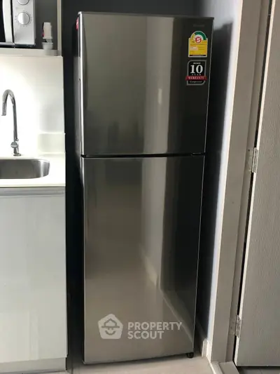 Modern kitchen with sleek stainless steel refrigerator and sink