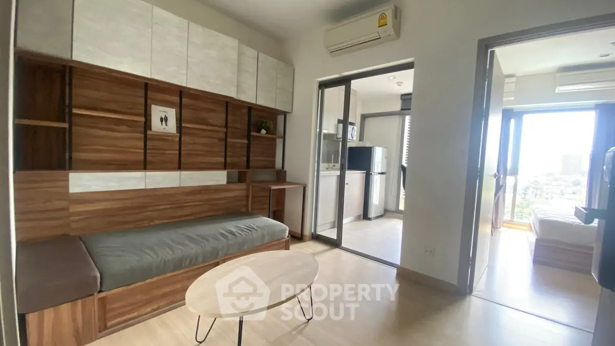 Modern living room with wooden accents and open layout to kitchen area