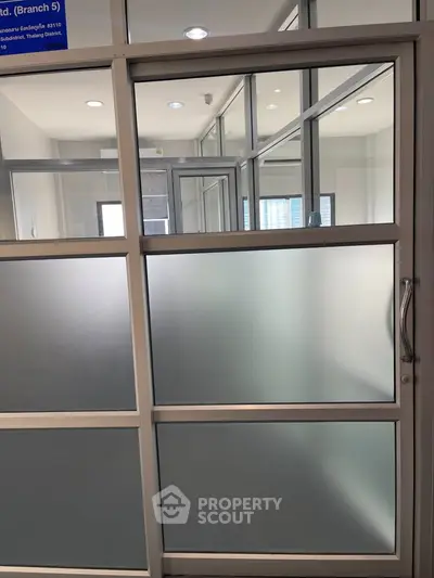 Modern office space with glass partitions and sleek design in prime location.