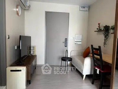 Cozy modern living room with sleek furniture and air conditioning, perfect for urban living.