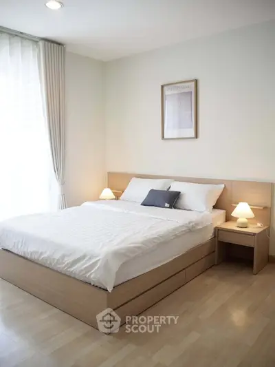 Modern bedroom with cozy lighting and minimalist decor, featuring a comfortable bed and stylish wooden furniture.