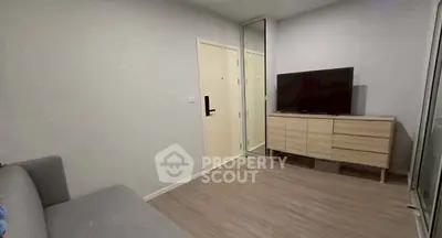 Modern living room with sleek furniture and TV, perfect for cozy relaxation.