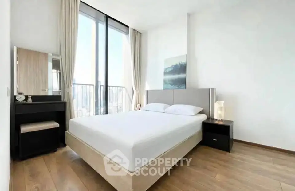 Spacious modern bedroom with large windows and elegant decor