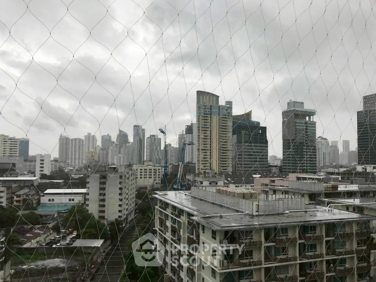 Stunning cityscape view from a high-rise building showcasing urban skyline and architecture.