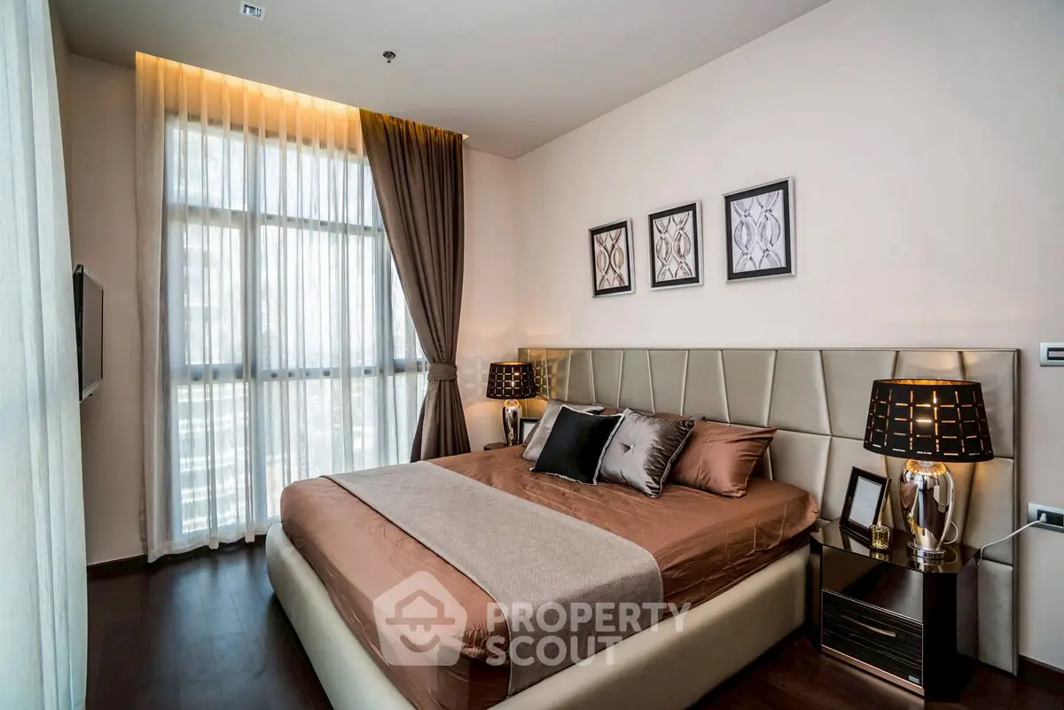 Luxurious bedroom with elegant decor and large window in modern apartment