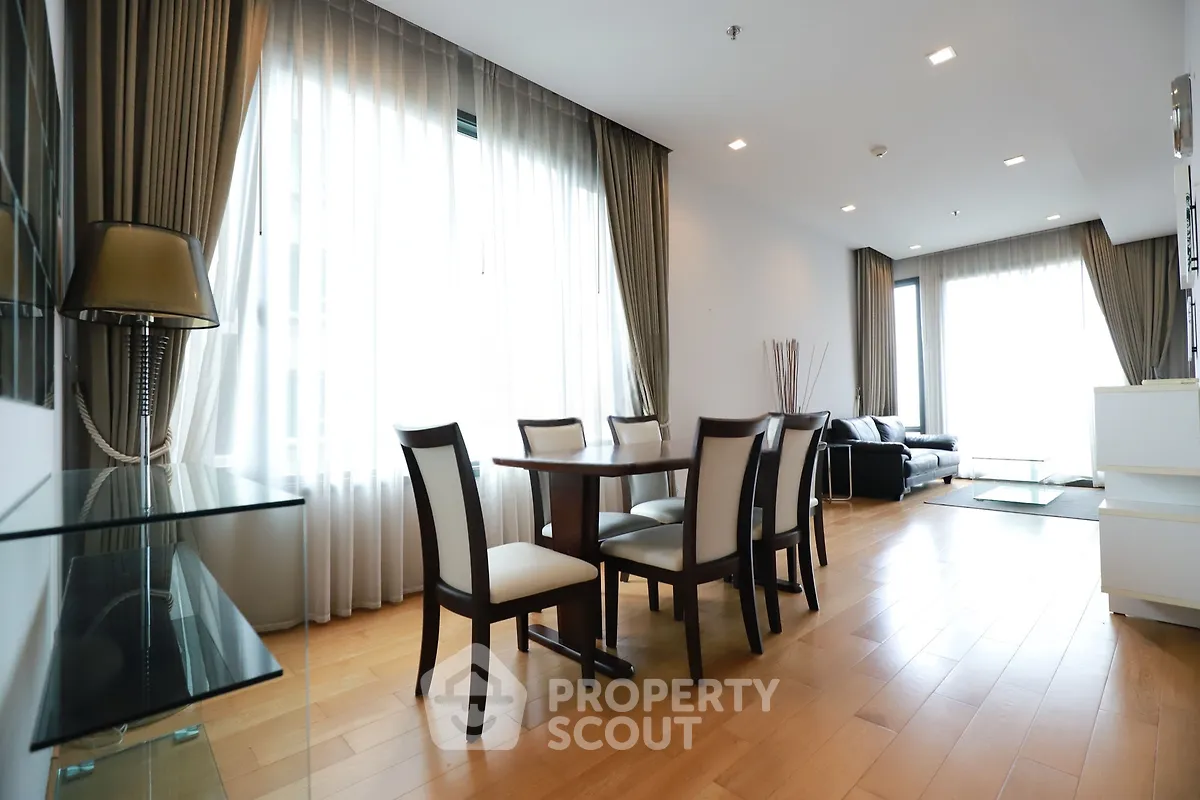 Spacious modern living room with elegant dining area and natural light