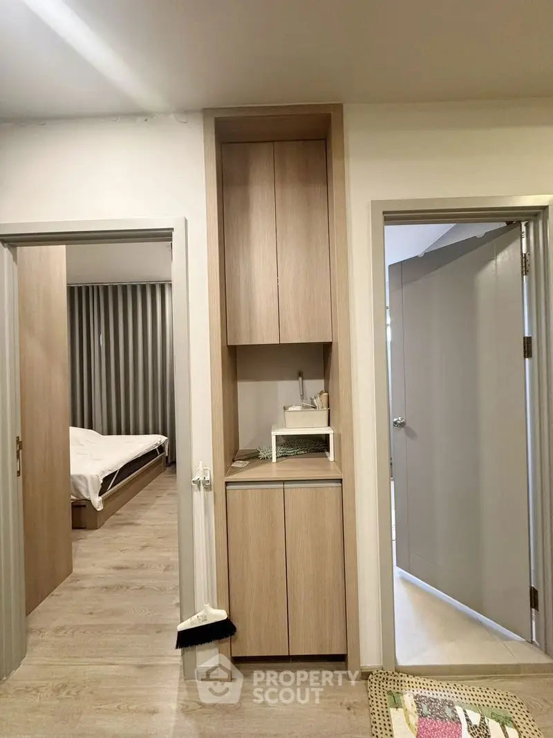 Modern apartment interior with wooden flooring and bedroom view