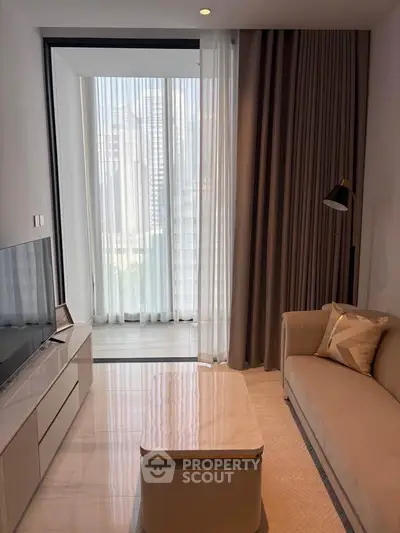 Modern living room with elegant decor and floor-to-ceiling windows