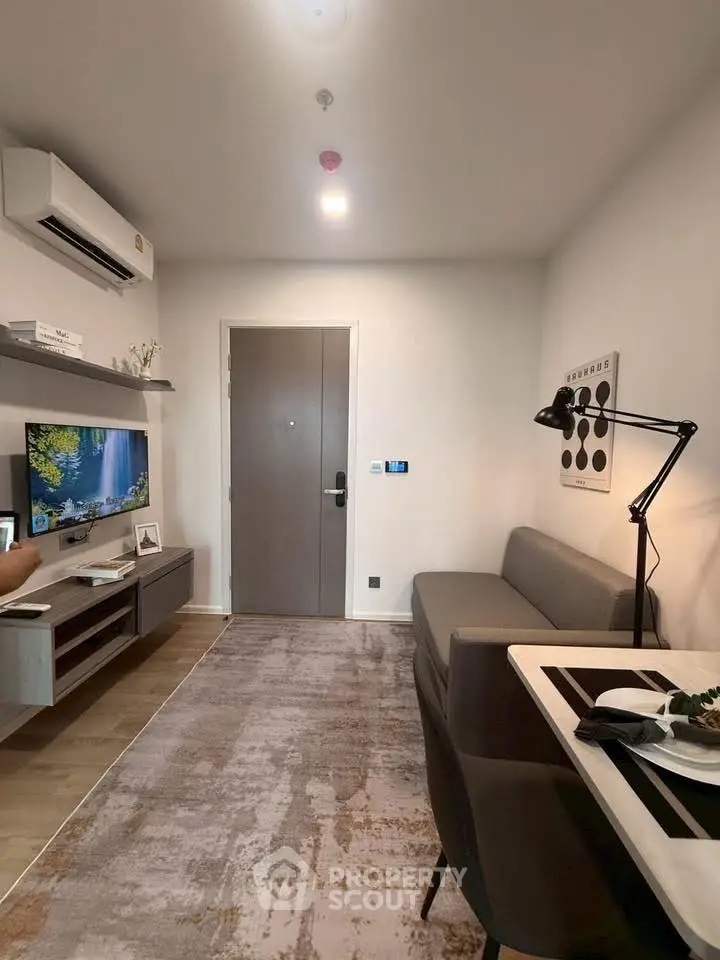 Modern living room with sleek furniture and wall-mounted TV