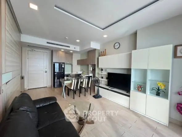 Modern living room with open kitchen and sleek furnishings