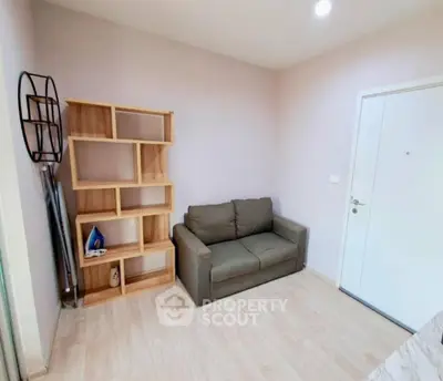 Cozy living room with modern sofa and stylish shelving unit, perfect for relaxation.