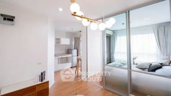 Modern apartment interior with open kitchen and cozy bedroom view.