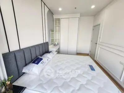 Spacious modern bedroom with stylish decor and ample storage space.