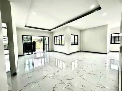 Spacious modern living room with marble flooring and large windows