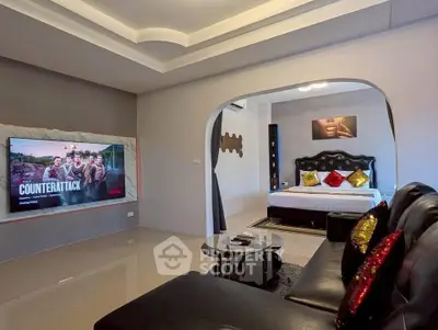 Luxurious living room with modern decor and spacious bedroom view
