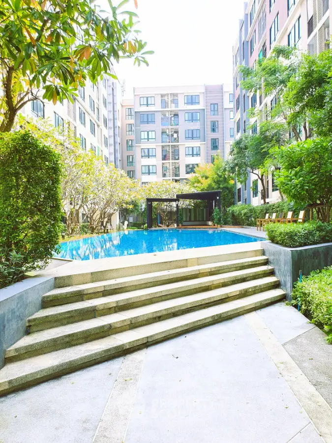 Luxurious residential complex with stunning pool and lush greenery