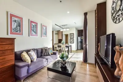 Spacious living room with modern decor and open layout in a stylish apartment.