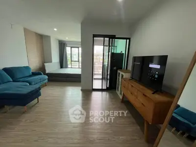 Modern studio apartment with stylish furniture and balcony access