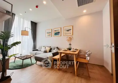 Stylish modern living room with cozy seating and elegant dining area, perfect for urban living.