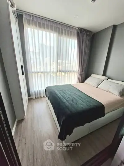 Cozy modern bedroom with large window and stylish decor