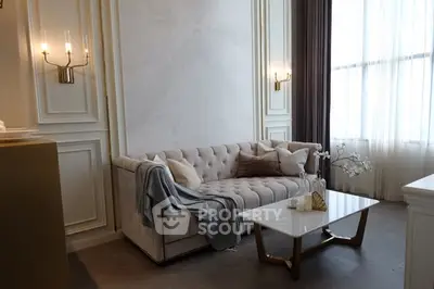 Elegant living room with plush sofa and marble coffee table in luxurious setting.