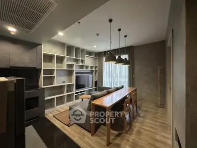 Modern living room with stylish furniture and built-in shelving