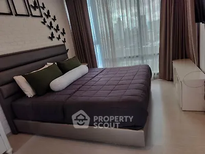 Luxurious bedroom with modern decor and city view, featuring elegant bedding and stylish wall art.