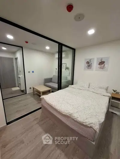 Modern bedroom with glass partition and cozy decor