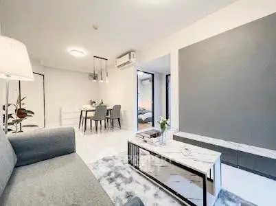 Modern living room with stylish decor and open dining area in a contemporary apartment.