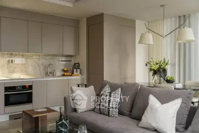 Modern open-layout kitchen and living room with stylish decor and neutral tones.