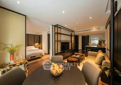 Luxurious open-plan living room with modern decor and cozy bedroom view, perfect for urban living.