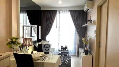 Modern living room with elegant dining setup and stylish decor in a cozy apartment.